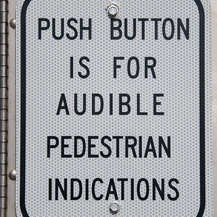 two children cross sidewalk