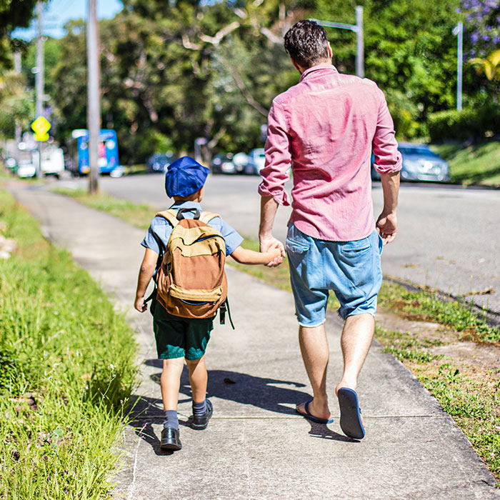 man and child on sidewalk