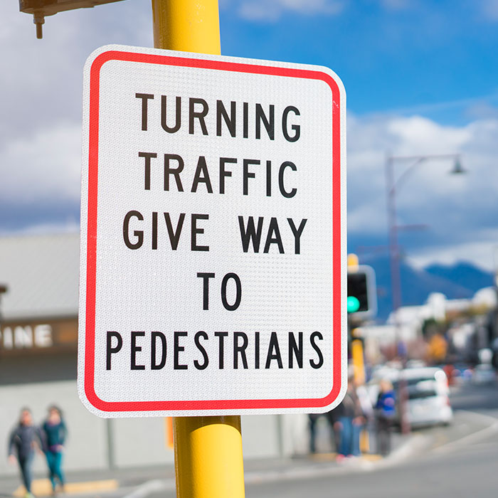 two children cross sidewalk