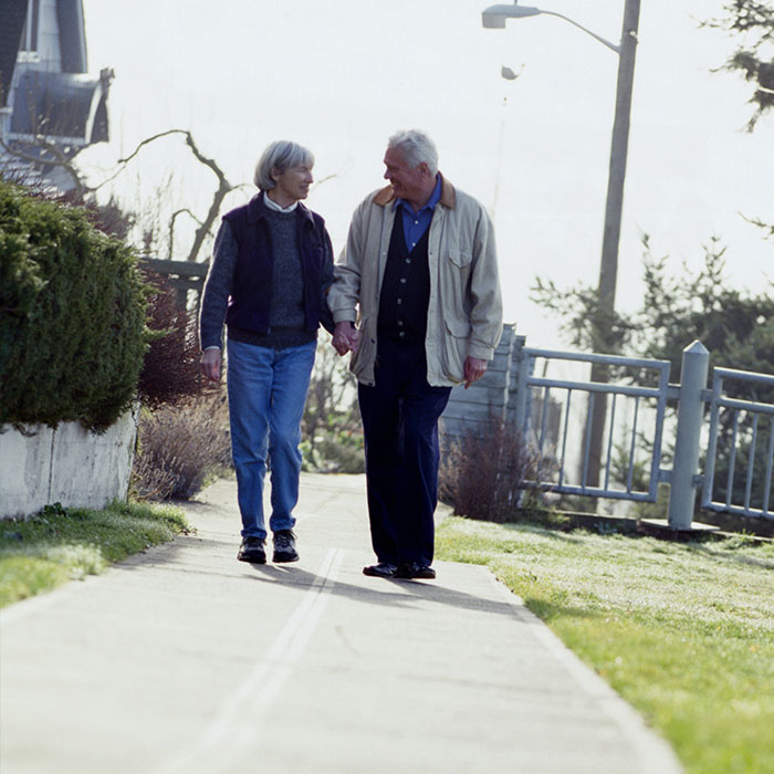 elderly couple on sidewalk